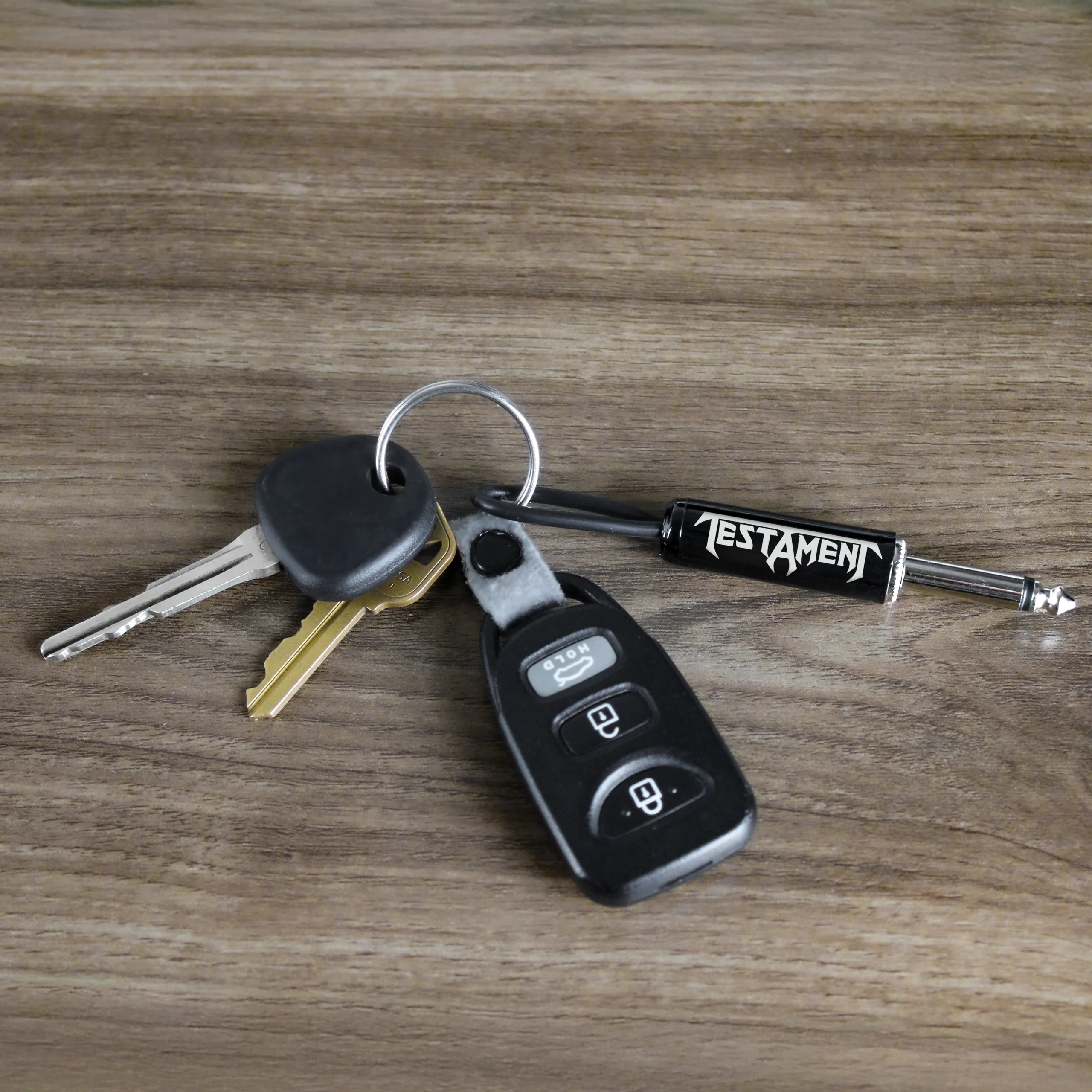 TESTAMENT LOGO GUITAR PLUG KEYCHAIN